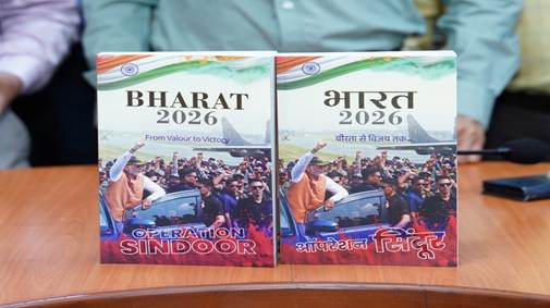 Two copies of the book "BHARAT 2026: From Valour to Victory" and its Hindi version "भारत 2026: वीरता से विजय तक..." placed upright on a wooden table.